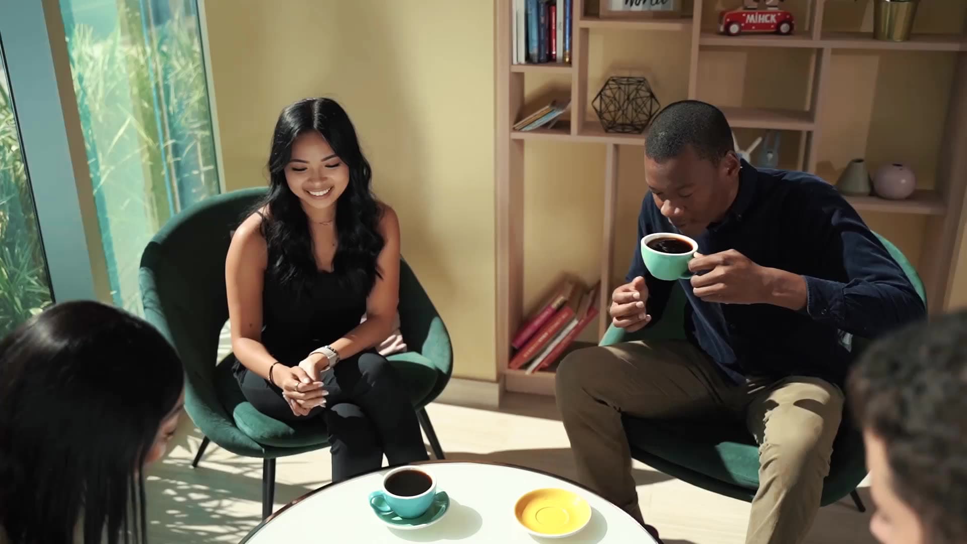Two friends talking over coffee at a café table